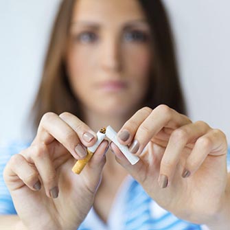 Woman breaking a cigarette